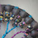 multicolor glass chip beads adorn blue and purple twisted wire branches with dominant gold tones